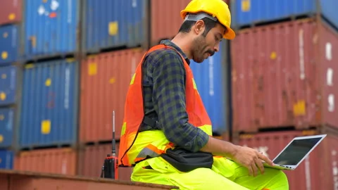 Foreman using laptop computer check Container loading real time Stock Footage 132549452