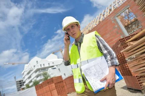 Foreman using walkie-talkie on construction site Foto stock