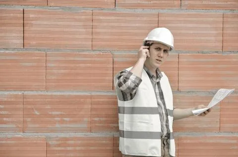 Foreman using walkie-talkie on construction site Foto stock