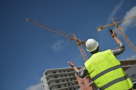 Foreman using walkie-talkie on construction site Stock Photos