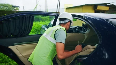Foreman in vest and hard hat walks toward the car Stock Footage 297600296