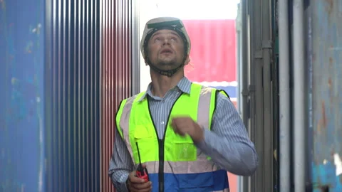 Foreman walking to checklist inventory and  control loading Containers box .. Stock Footage 242308249