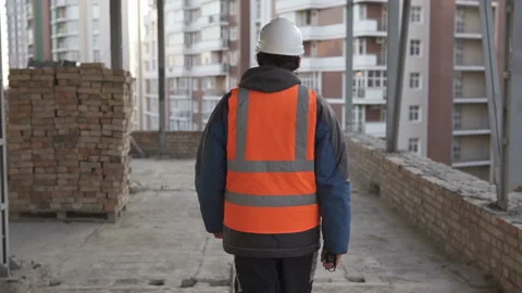 The foreman walks around the construction site, checks the work done. Stock Footage 157492895