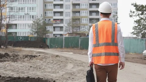 Foreman on the way to the construction site of a high-rise monolithic building. Stock Footage 172008895
