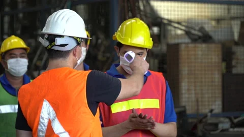 Foreman wear protective face mask scanning body temperature measuring fever b Stock Footage 139097068