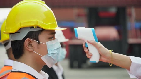 Foreman wear protective face mask scanning body temperature  to worker distan Stock Footage 154685861