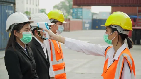 Foreman wear protective face mask scanning body temperature  to worker distan Stock Footage 154686088