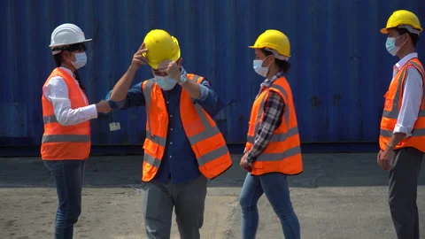 Foreman wear protective face mask scanning body temperature  to worker distan Stock Footage 156386108