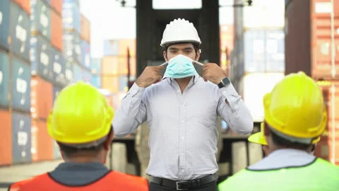 Foreman Wearing protective face mask explain to social distancing to worker Stock Footage 140276377
