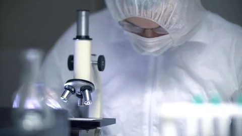 Forensic Crime Scientist Gathering Sample and Placing into Evidence Bag in Lab Stock Footage