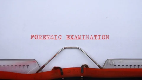 Forensic examination - phrase printed on an old typewriter in red letters Video stock 128400064