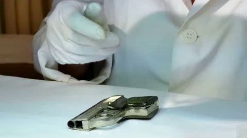 Forensic Examines a Pistol Stock Footage 82412846