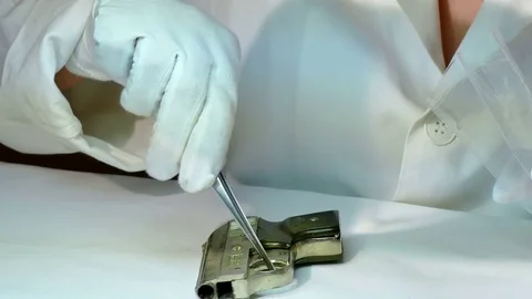 Forensic Examines a Pistol Stock Footage 82413037