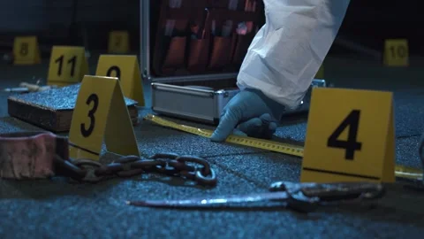 Forensic expert hard working at ritualistic crime scene with occult clues. Stock Footage 286754780