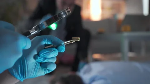 Forensic expert in protective suit collects evidence. Seeking Evidence And Clues Stock Footage 221670571