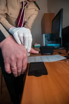 Forensic expert taking fingerprints for identification with ink pad and rol.. Stock Photos