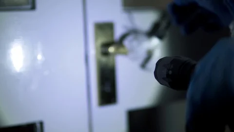 Forensic scientist brushing door handle for fingerprints at crime scene Stock Footage 110714131