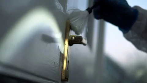 Forensic scientist brushing door handle for fingerprints at crime scene Stock Footage 110714272