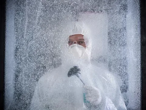 Forensic scientist dusting broken glass for fingerprints at crime scene Stock Photos
