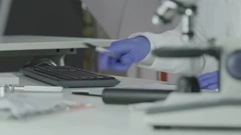 Forensic Scientist Inputs Data and Information Onto a Computer 스톡 동영상 208708653