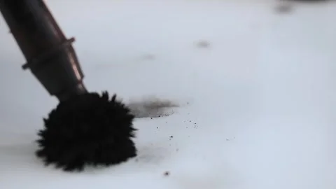 A forensic scientist runs a brush over a surface and reveals a fingerprint. Stock Footage 316727214