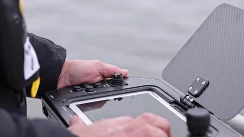 Forensic technician operating underwater robot from handheld computer 스톡 동영상 271338217