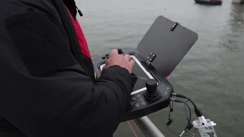 Forensic technician operating underwater robot from handheld computer 스톡 동영상 271338220