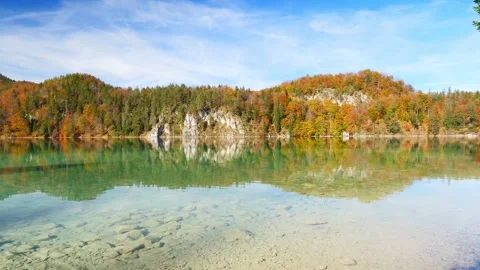 Forest and mountain reflections on an autumn lake during peak fall foliage in Stock Footage 309092451