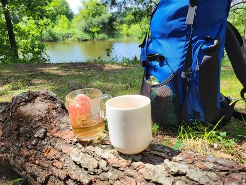 Forest and river. Cups of tea and tourist Stock Photos