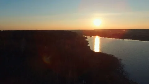Forest and river in sunset. Sun flare country rural landscape. Aerial survey Stock Footage 107807317