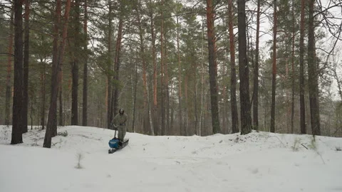 Forest ATV accident. Snowcovered trail leads to ATV tipping over in winter woods Stock Footage 346251885