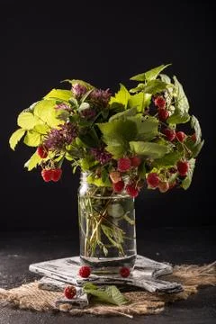 Forest berries with leaves on rustic  background. Stock Photos