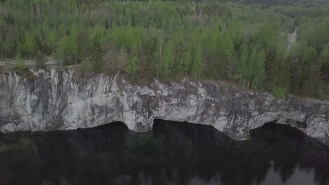 Forest on a cliff over a pond. Stock Footage 149108325