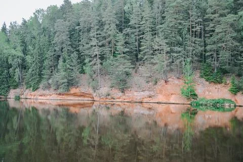 Forest Cliffs Reflected in Calm River Water Landscape Stock Photos
