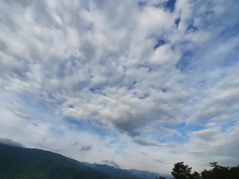 Forest &amp; clouds in the sky Stock Photos