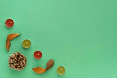 Forest cosy flat lay composition. Frame from bump, bark, candles on green bac Stock Photos