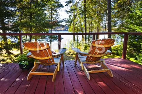 Forest cottage deck and chairs Stock Photos