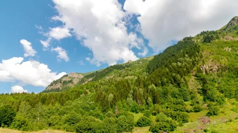 Forest covered mountain and moving clouds. Landscape time lapse Stock Footage 287090956