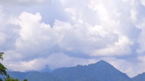 Forest-Covered Mountain Peak Beneath Dramatic Clouds Video stock 346236622