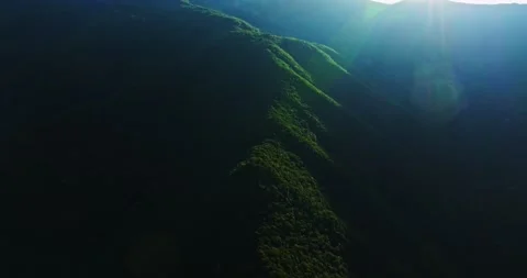Forest Covered Rainforest Mountain Ridge Lit By Sunrays Flares Sunrise Humid Stock-Footage 289415251
