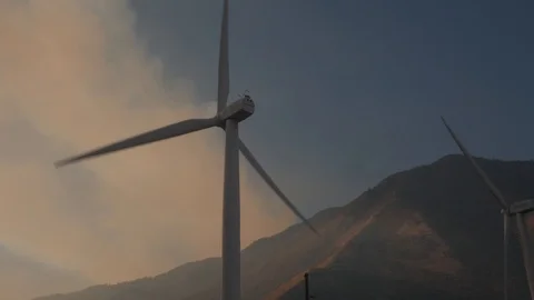 Forest fire behind wind turbines Stock Footage 95268532