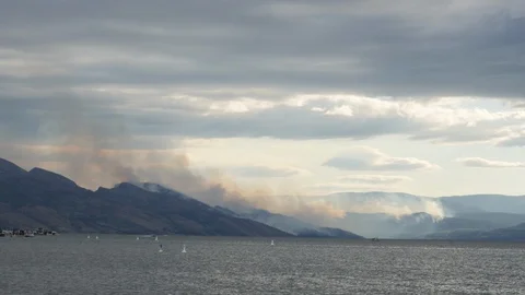 Forest Fire time lapse burning trees on a mountain and lake time lapse 4k. Stock Footage 96493937