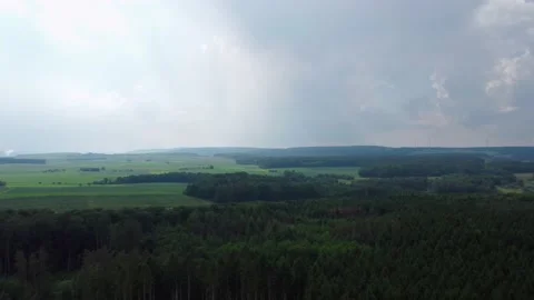 Forest on a hill in the distance it starts to rain Vídeos de archivo 155598253