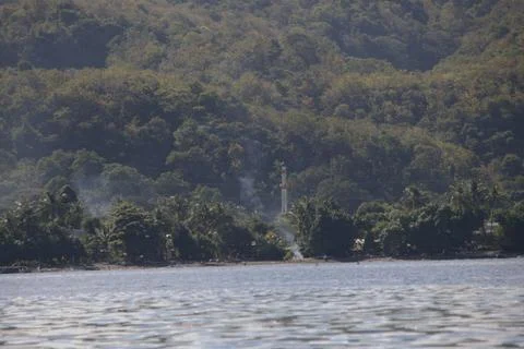 A forest with a lake in the background Stock Photos
