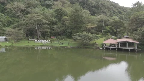 Forest lake with cabins and dense vegetation in tropical mountainous region Stock Footage 343904638
