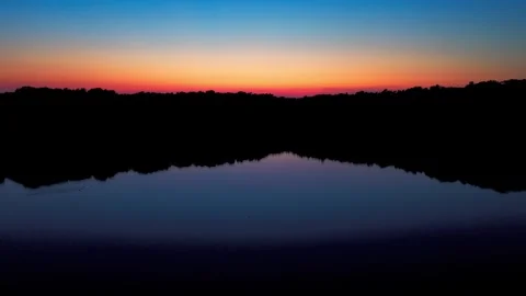 Forest lake at dusk with water reflection Stock Footage 340920434
