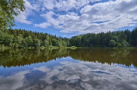 Forest lake reflection sky clouds summer Tauern pond Ossiach Carinthia Austria Stock Photos