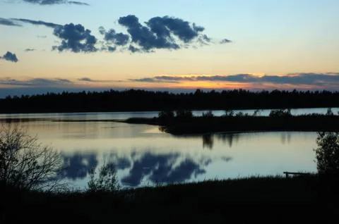 Forest lake at sunset Stock Photos