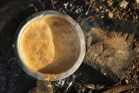 In forest make a fire warm up boil milk. tea making at Traditional way Stock Photos