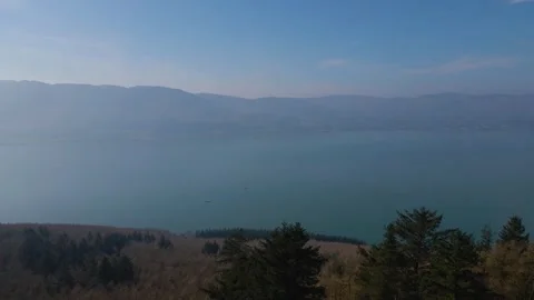Forest on mountain top with large blue lake in background. Stock Footage 306470874